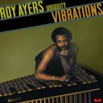 Step into the golden era of soul-jazz with the long-awaited vinyl reissue of “Vibrations” by Roy Ayers Ubiquity — a record that captures the unmistakable warmth, groove, and sophistication that defined Roy Ayers’ sound at its peak. Originally released in 1976, “Vibrations” stands as a cornerstone in Ayers’ catalog, marking a moment where his signature blend of jazz, funk, and soul reached a refined, deeply cohesive form. Building on the foundations laid in earlier works, this album presents a tighter, more focused musical vision without sacrificing the lush textures and emotional depth that made his music resonate worldwide. Roy Ayers was a pioneering vibraphonist, composer, and producer whose influence stretches far beyond jazz into R&B, neo-soul, and hip-hop. Often referred to as the “Godfather of Neo Soul,” Ayers crafted a sound that feels both timeless and forward-thinking, pairing silky vocals with hypnotic grooves and rich instrumental arrangements. His work throughout the 1970s helped shape the sonic DNA of modern Black music, and “Vibrations” is one of its purest expressions. The album flows effortlessly between moods: from the jazz-inflected elegance of ‘Searching’ to the irresistible funk pulse of ‘The Memory,’ the dancefloor-ready ‘One Sweet Love to Remember,’ and the laid-back, atmospheric title track ‘Vibrations.’ Each track showcases a masterful balance between musicianship and groove, brought to life by a stellar ensemble of collaborators who elevate every moment. Beyond its original impact, “Vibrations” has taken on a second life through hip-hop. Its grooves, breaks, and melodies have been extensively sampled by generations of producers and artists, becoming a foundational source for crate diggers and beatmakers alike. Tracks from the album have been reinterpreted and flipped by influential names such as A Tribe Called Quest, J Dilla, Dr. Dre, and Common, cementing its legacy as a vital bridge between 1970s soul-jazz and contemporary hip-hop culture. After almost two decades out of print, we are pleased to present this much-needed vinyl reissue of an essential album in Roy Ayers’ career. Whether you’re discovering it for the first time or returning to a beloved classic, this album remains an essential piece of musical history. Pressed on 180g vinyl.